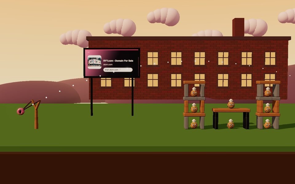An advert on the billboard behind a bakery fortress in Doughnut Slingshot